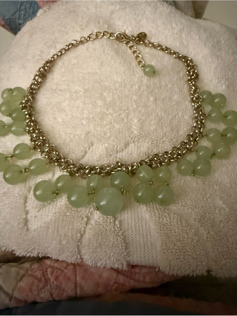 Green bauble necklace with rows of 2 hanging baubles around front